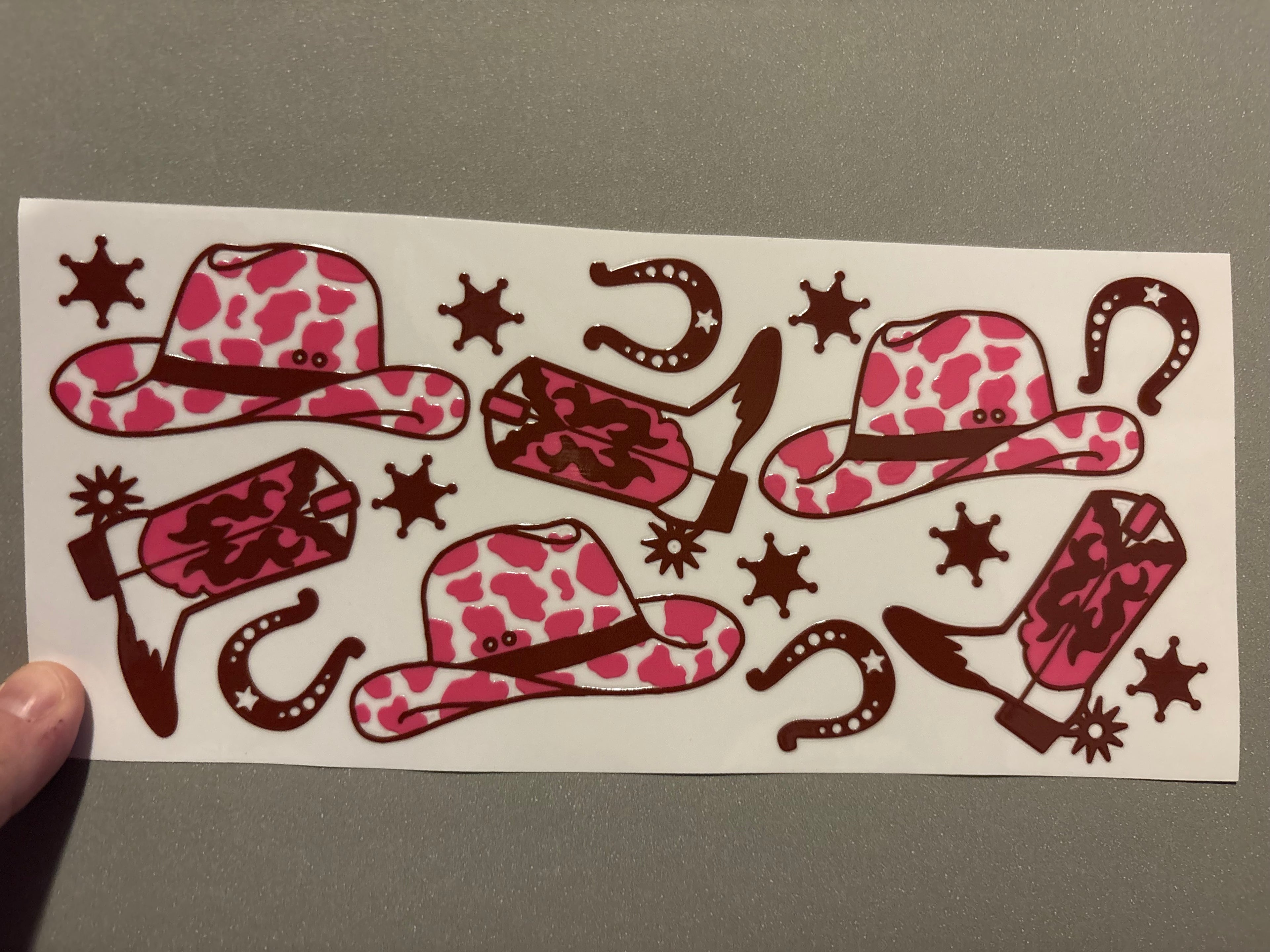 Pink cow print cowboy hat, horseshoes, cowboy boots, stars