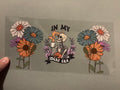 In my idgaf era, skeleton with coffee, tall flowers on each side