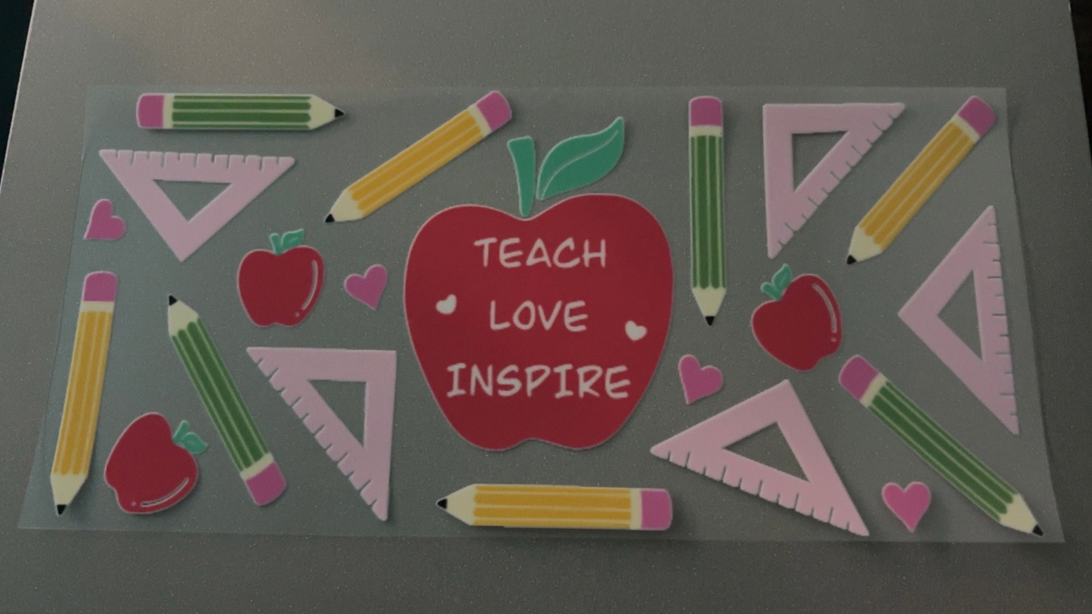 Teach, love, inspire, apples, pencils, hearts, triangles