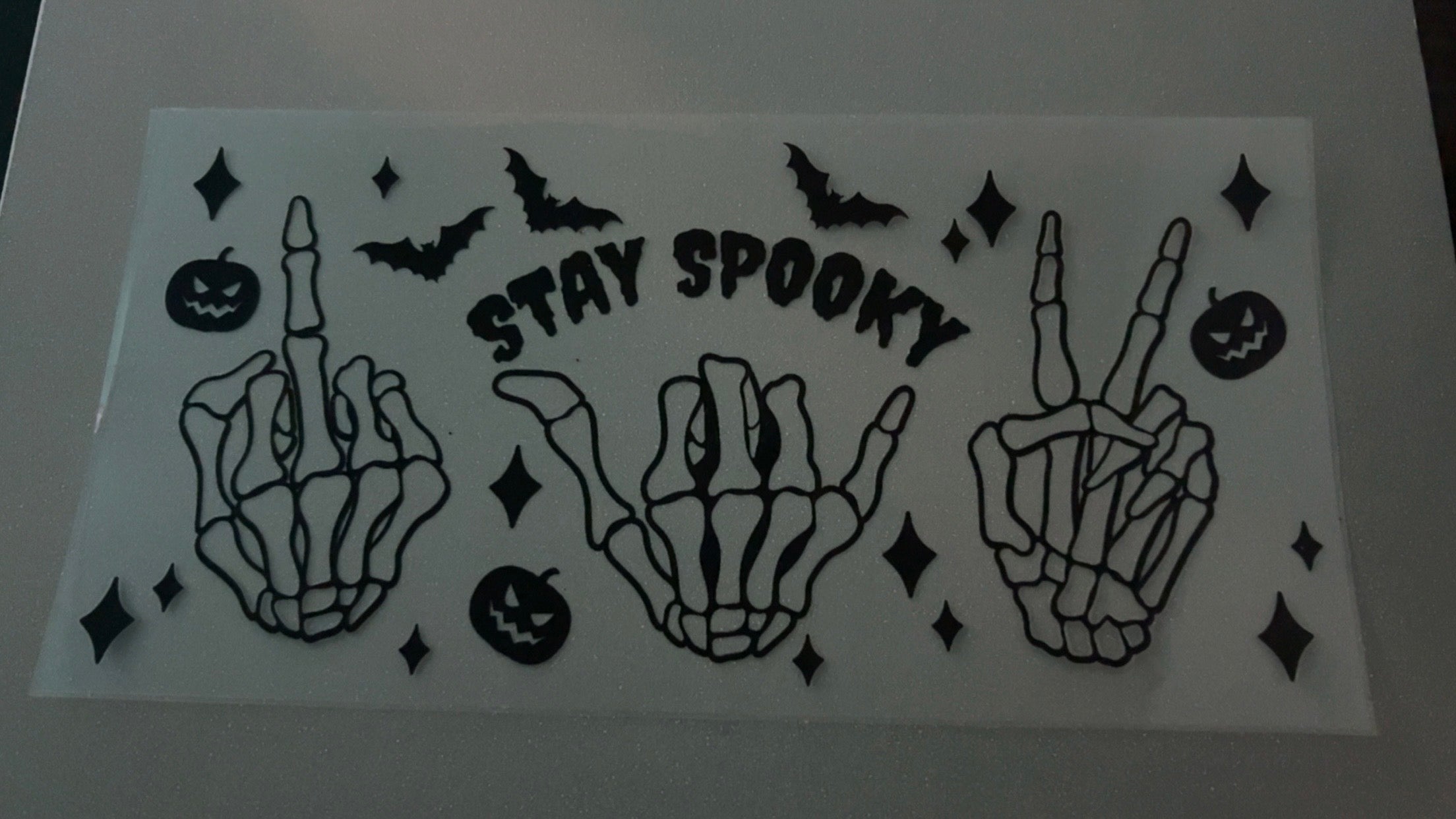 Stay spooky, skeleton hands, bats, pumpkins, stars