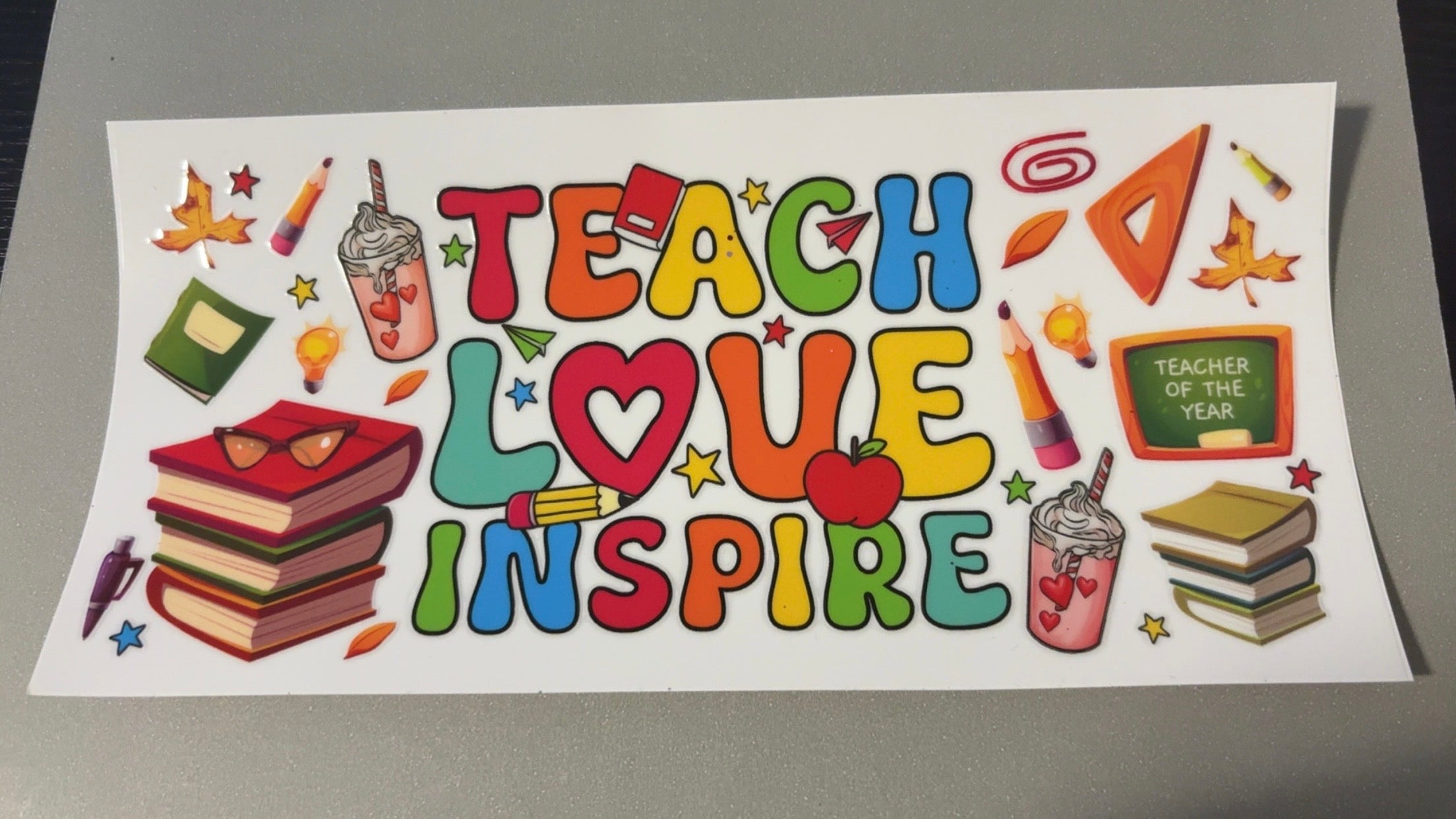 Teach, love, inspire, stack of books