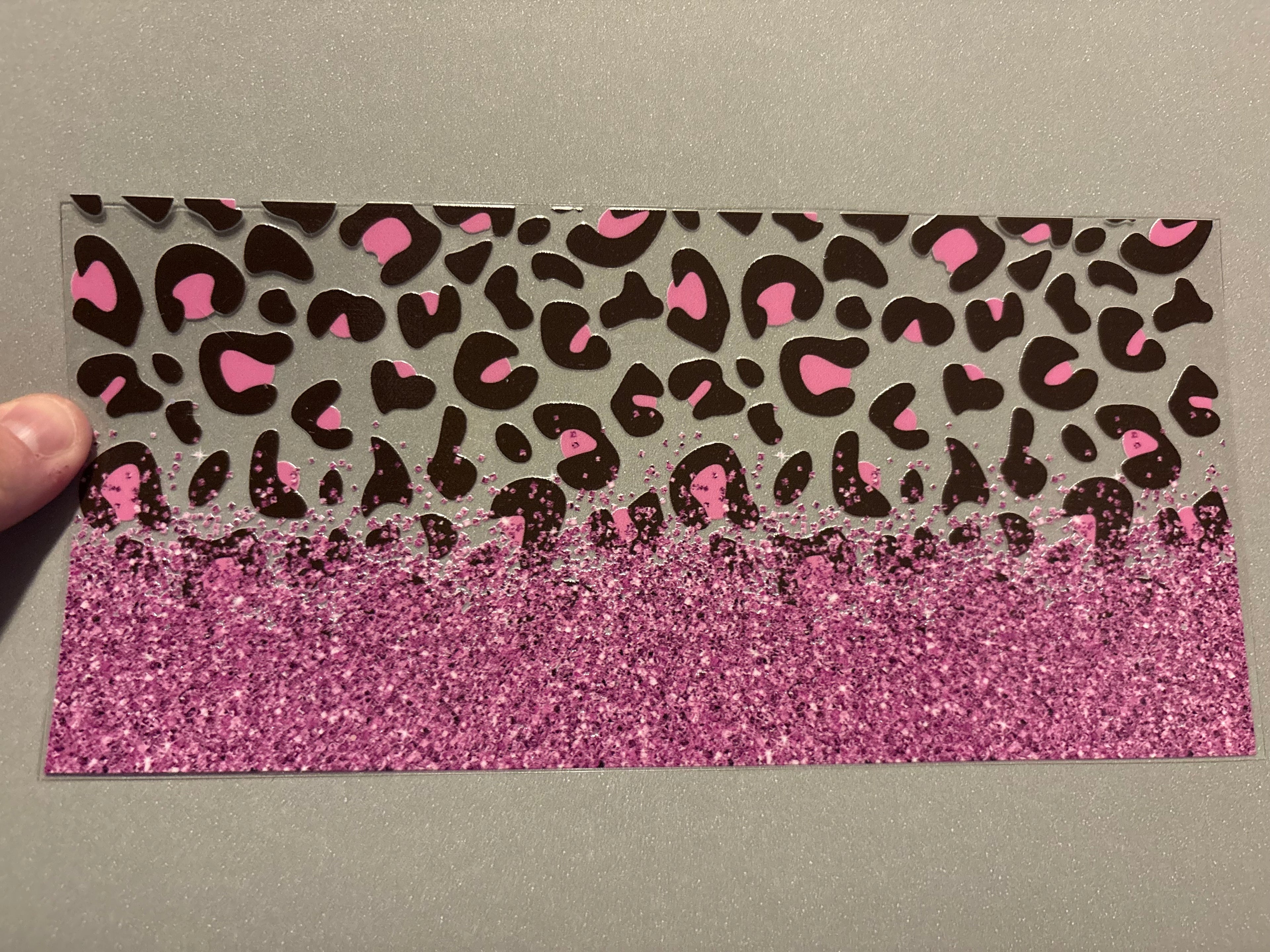 Pink cheetah print, pink glitter across the bottom