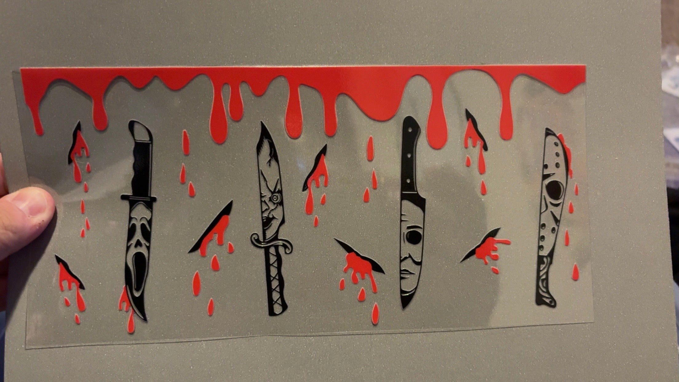 Scary faces on knives, with cuts & blood drips