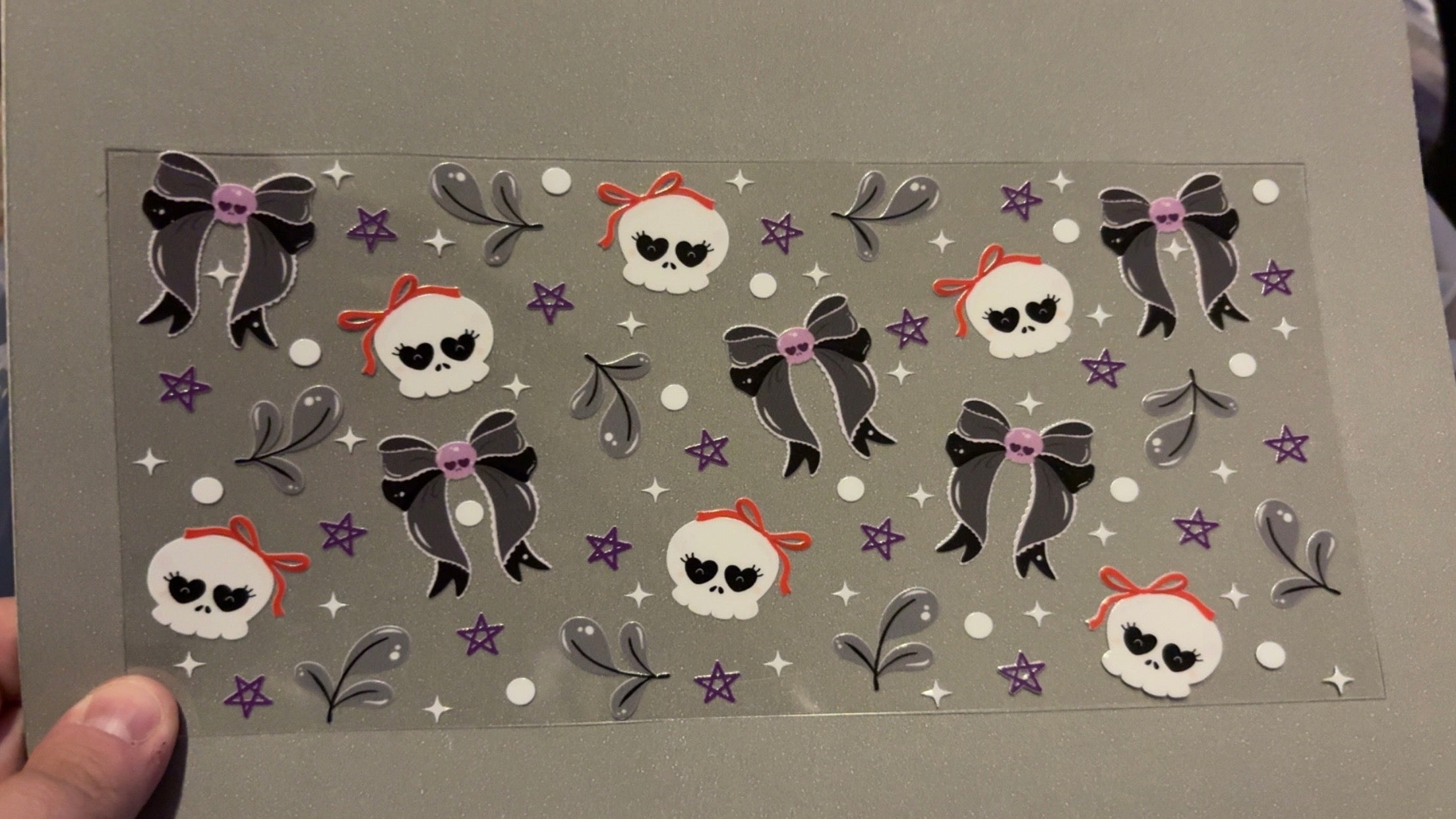 Skull heads with orange bows, purple stars, skullhead bows, white sparkles