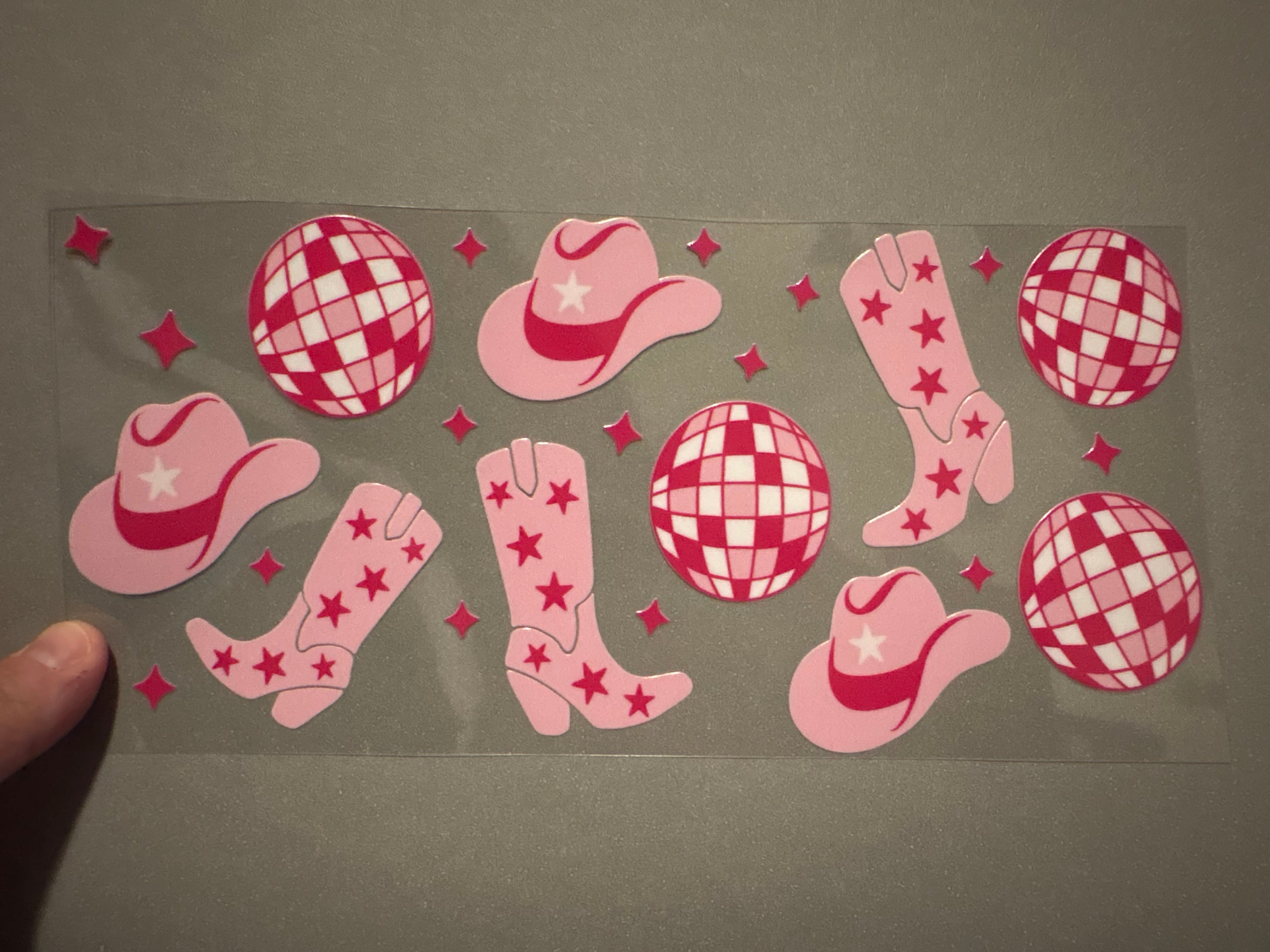 Pink disco balls, pink cowboy hats, pink boots with stars, pink stars