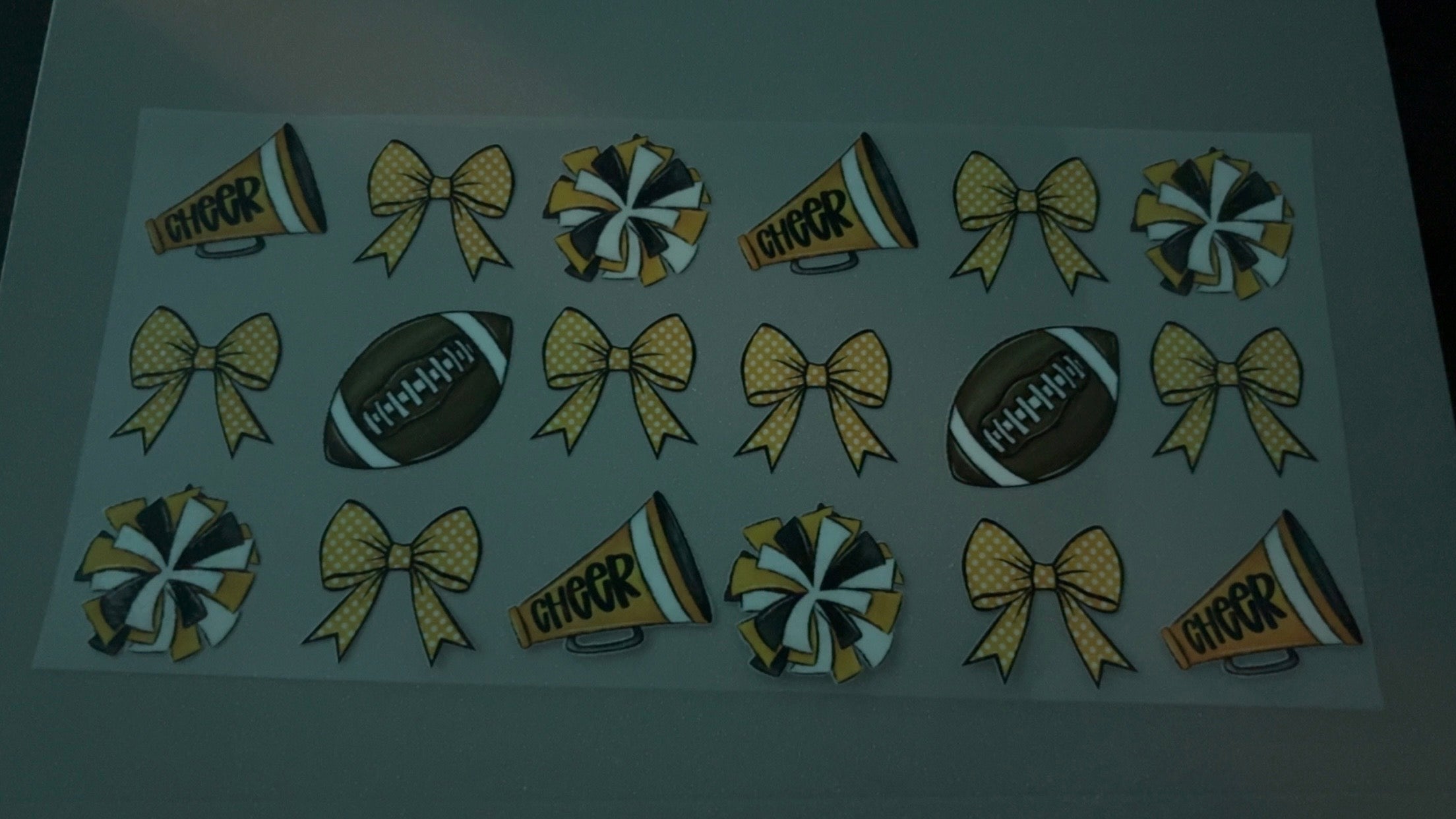 Yellow cheer pompoms, yellow bows & footballs