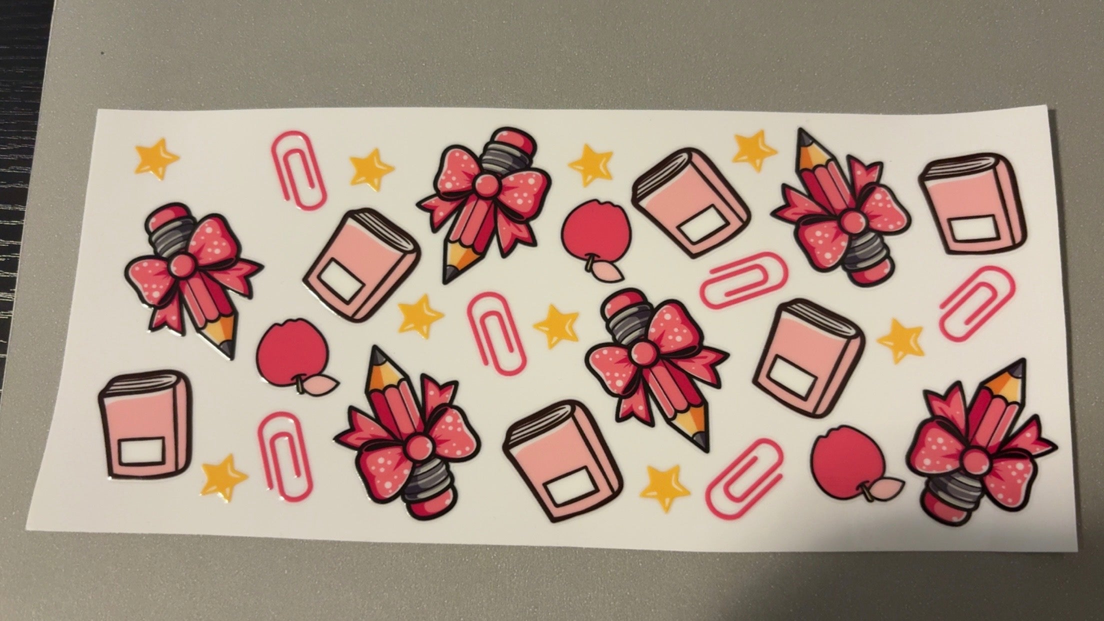 Notebooks, pencils with bows, apples, paperclips, stars