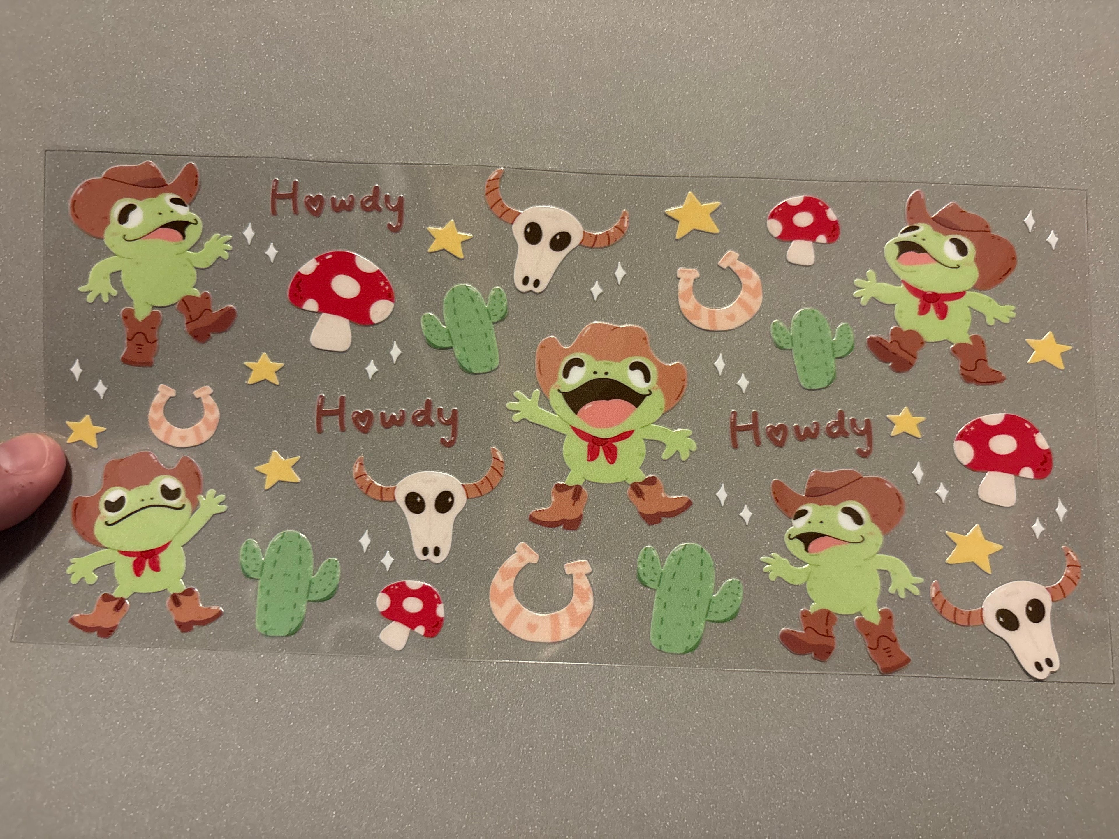 Howdy, frogs with cowboy boots & cowboy hats, stars, mushroom, cactus, horseshoe
