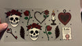 Skulls with roses on heads, key, candle