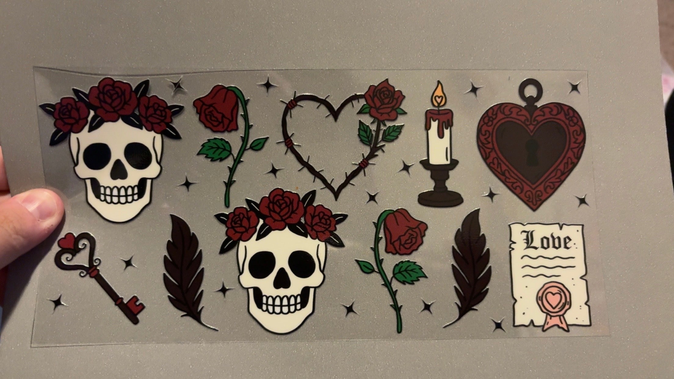 Skulls with roses on heads, key, candle