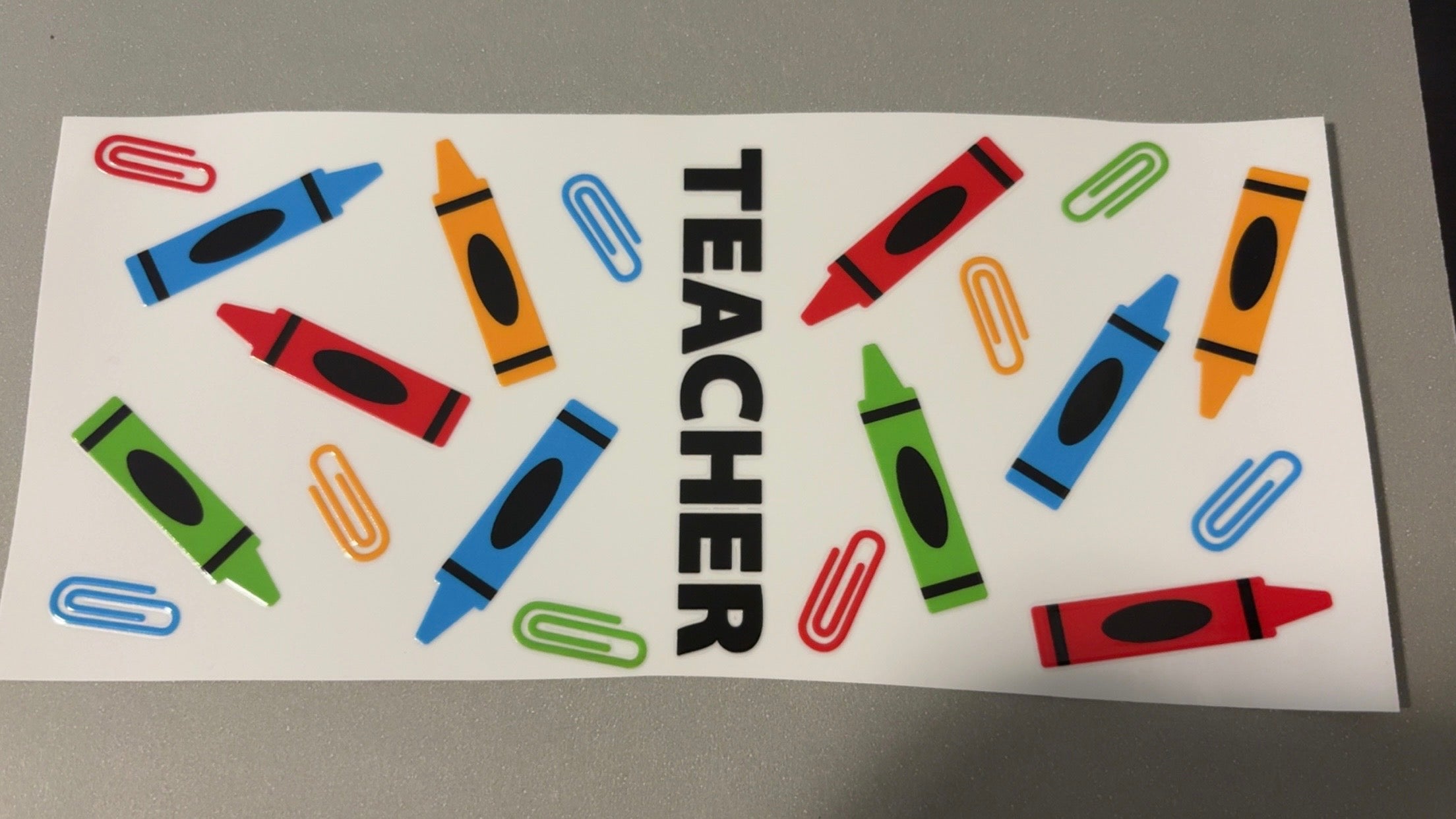 Teacher, crayons & paperclips