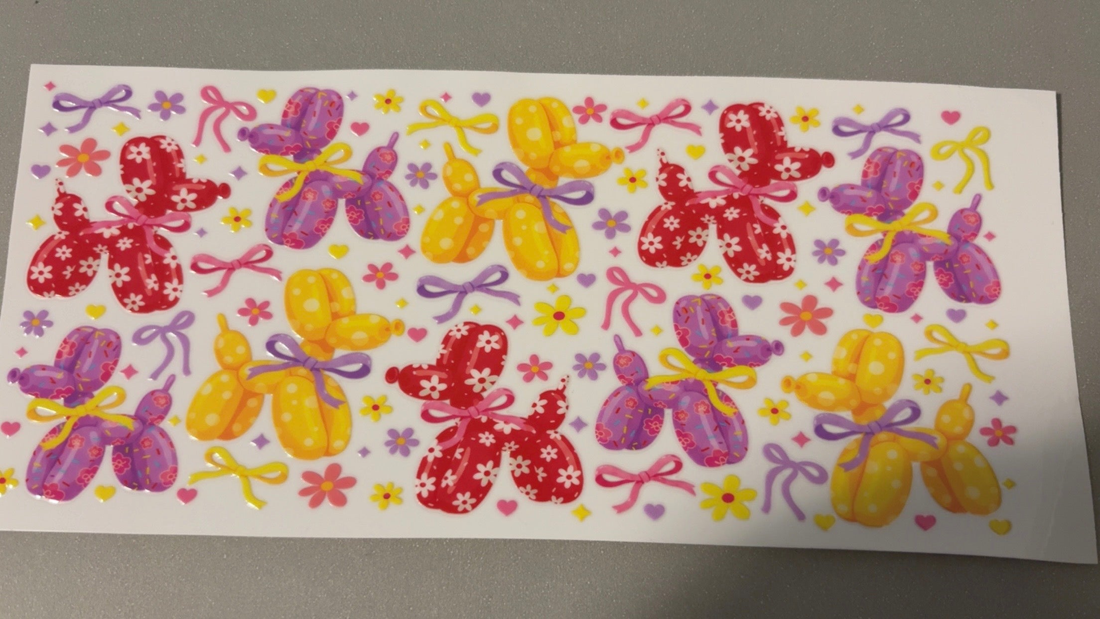 Red, purple, yellow balloon dogs, bows & stars