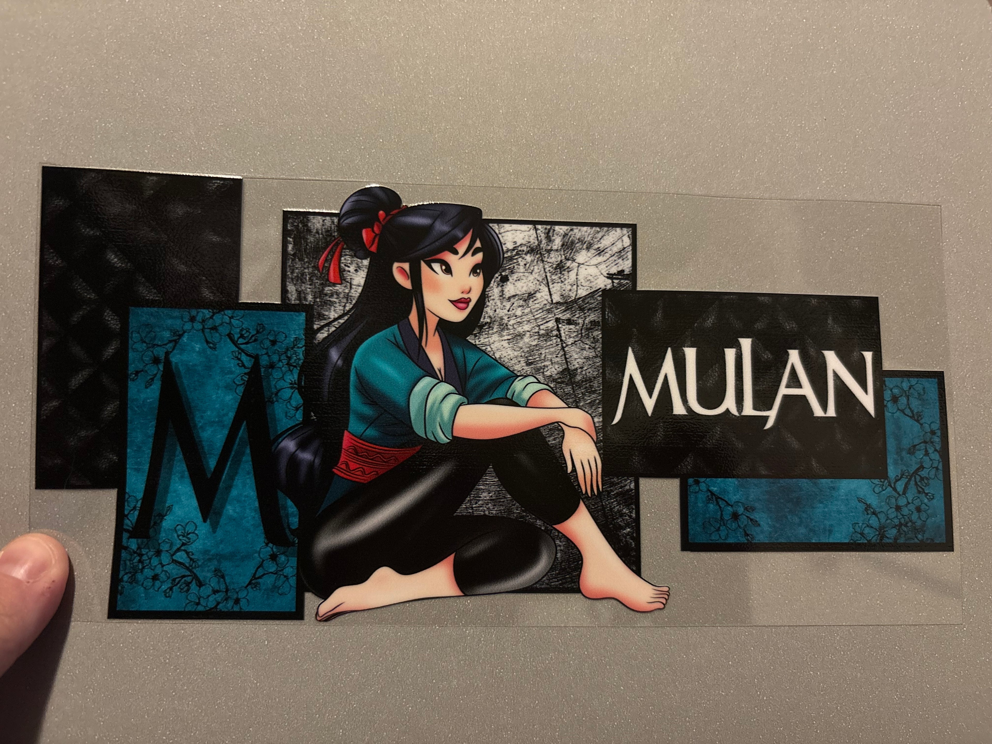 Mulan, teal shirt, black pants, barefoot