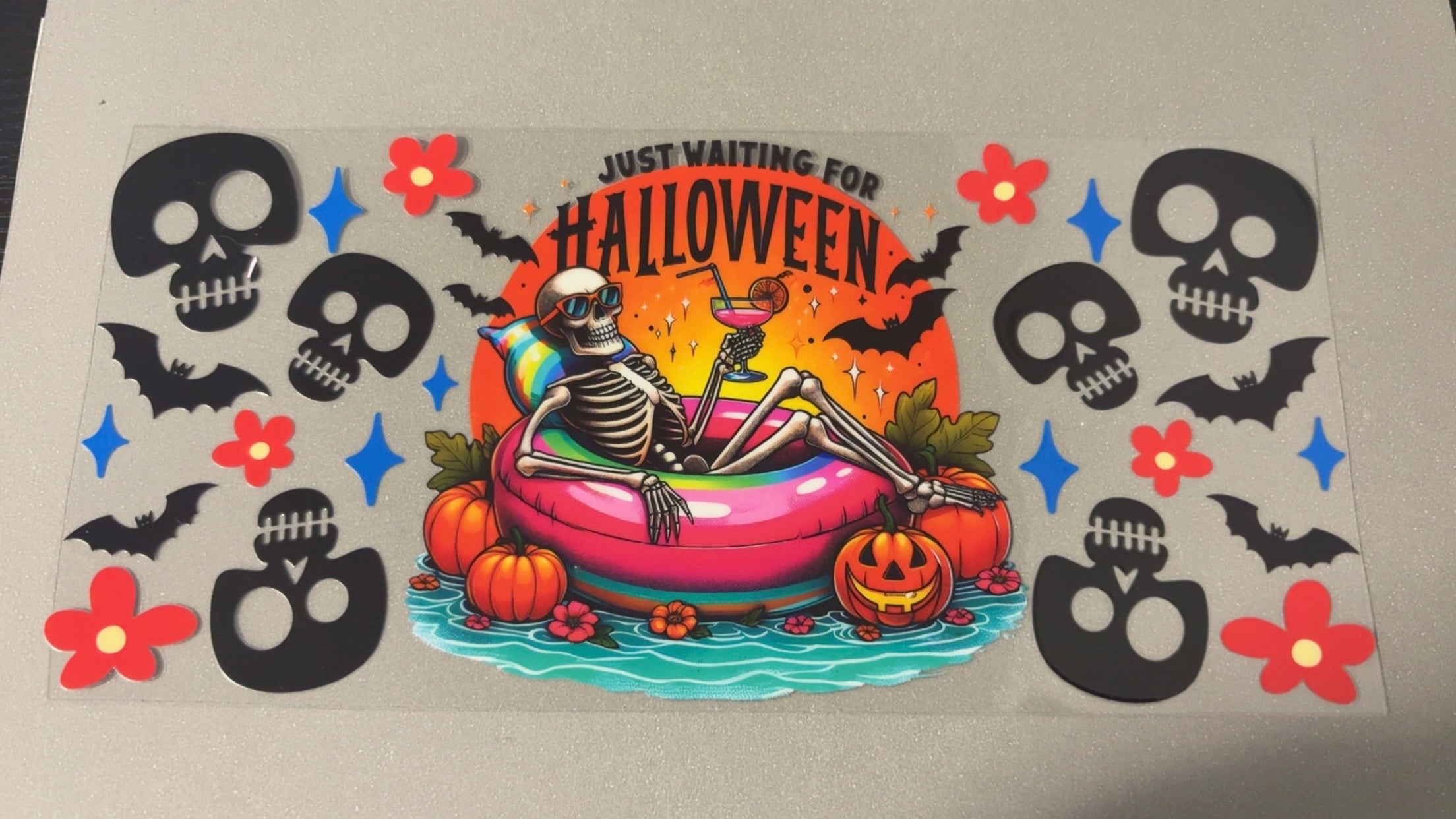 Waiting for Halloween with skeleton on tube, flowers, skulls